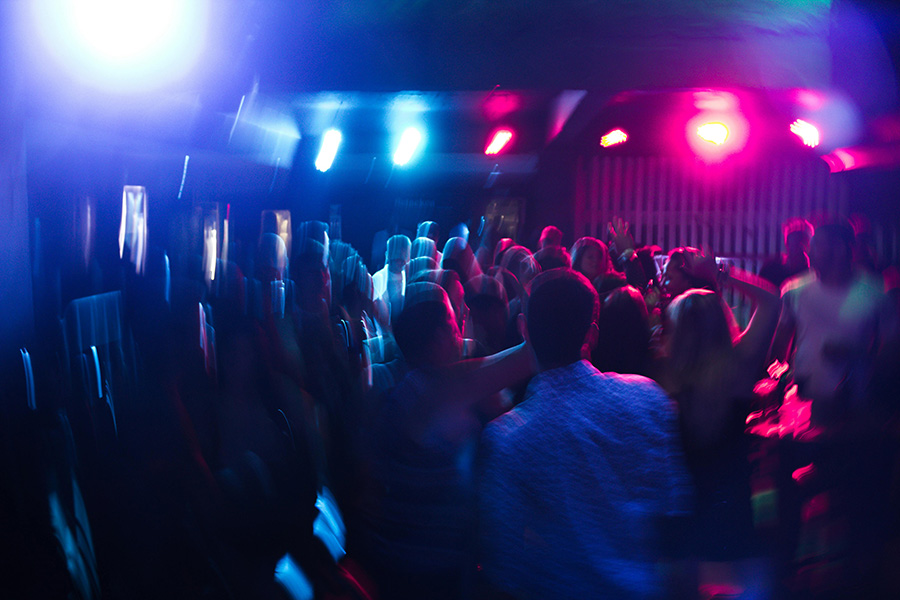 Ultimate Disco Dorset wedding DJ creating packed dance floor atmosphere with vibrant lighting