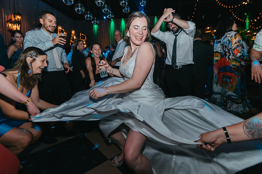Wedding DJ Dorset creating packed dance floor atmosphere with bride dancing at reception