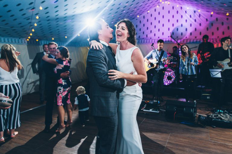 Hampshire wedding band performing live while bride and groom dance on a busy reception dancefloor