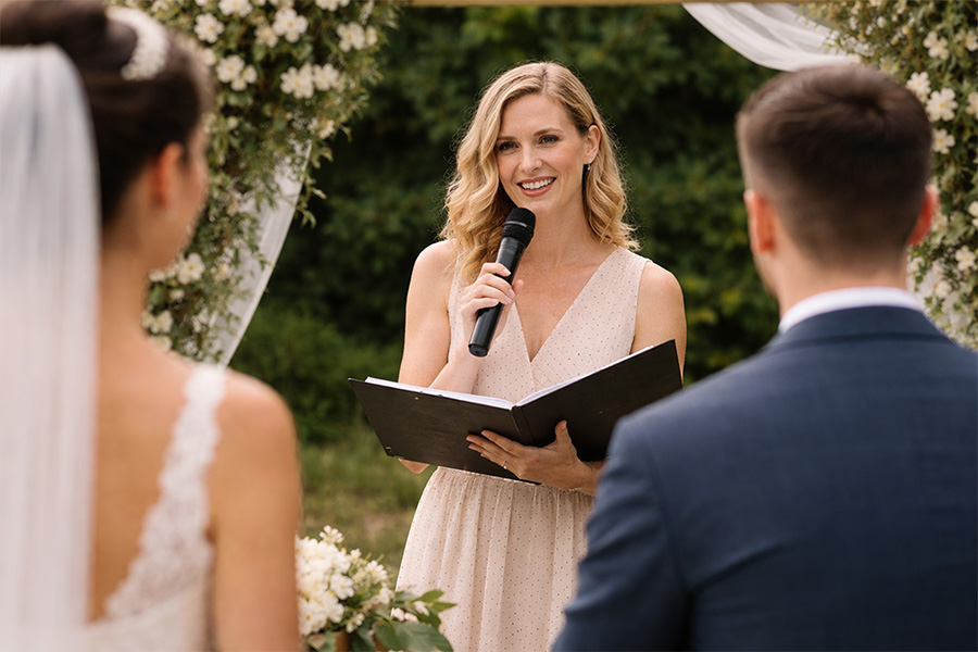 Wedding celebrant speaking during outdoor ceremony at Hampshire wedding
