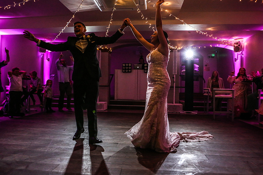 Bride and groom performing their first dance at wedding reception after dance lessons