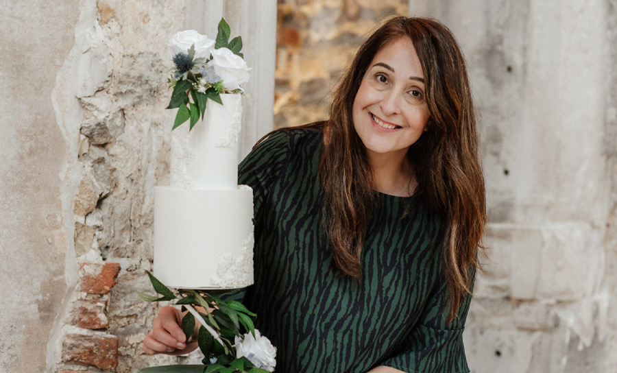 Helena Jane wedding cake designer in Dorset holding a bespoke wedding cake