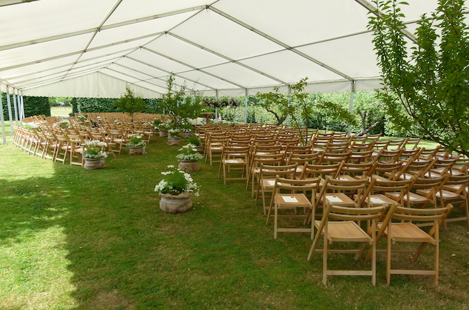 Wedding ceremony setup inside clearspan marquee by Camelot Marquees Dorset