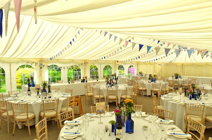 Wedding reception tables inside lined marquee by Camelot Marquees Dorset