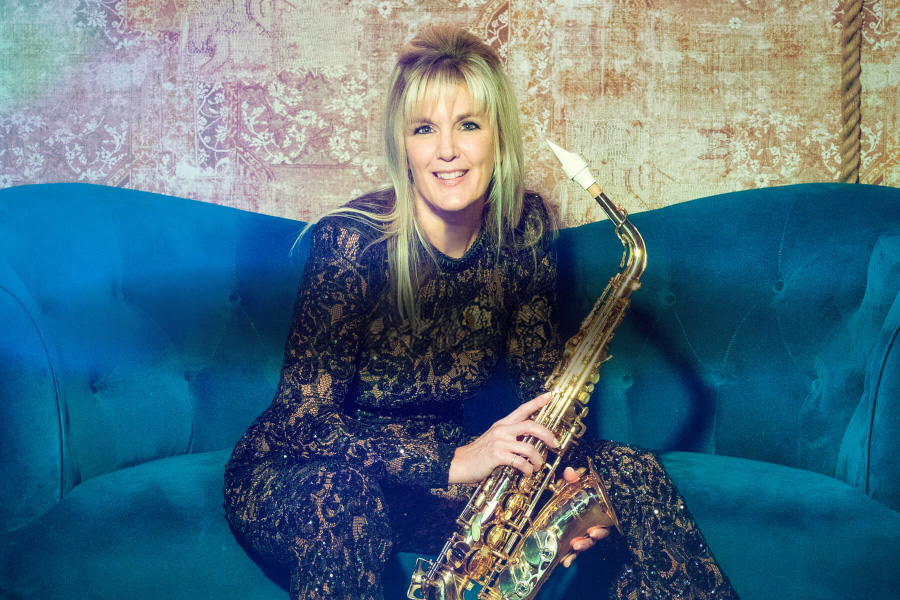 Claire Manners live sax wedding saxophonist seated with saxophone