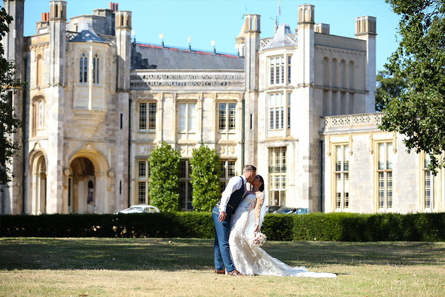 Bride and groom at Dorset country house wedding venue with historic building backdrop