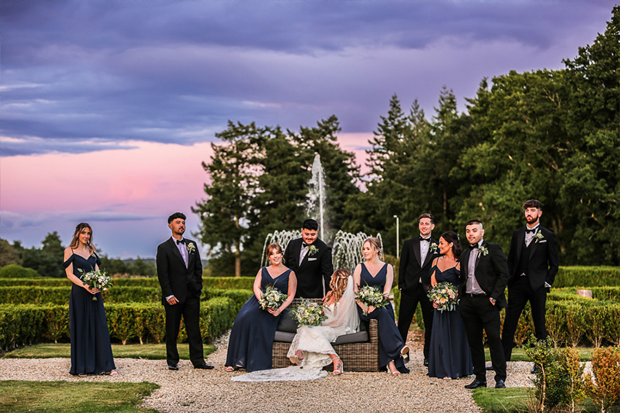 Bridal party at Dorset outdoor wedding venue with garden setting at sunset