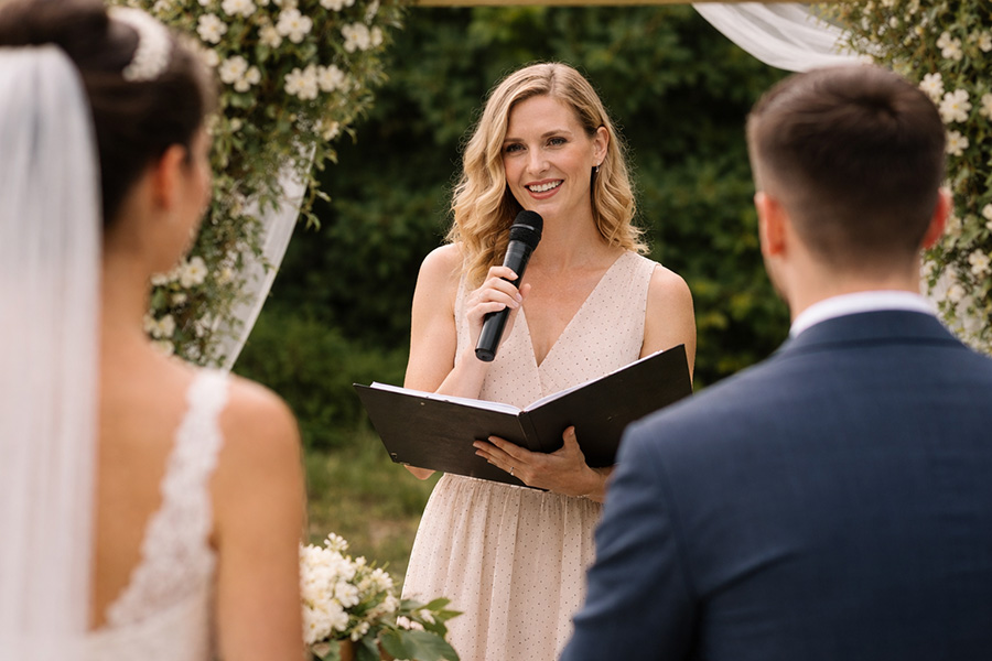 Wedding celebrant leading an outdoor ceremony for a bride and groom at a Dorset wedding venue