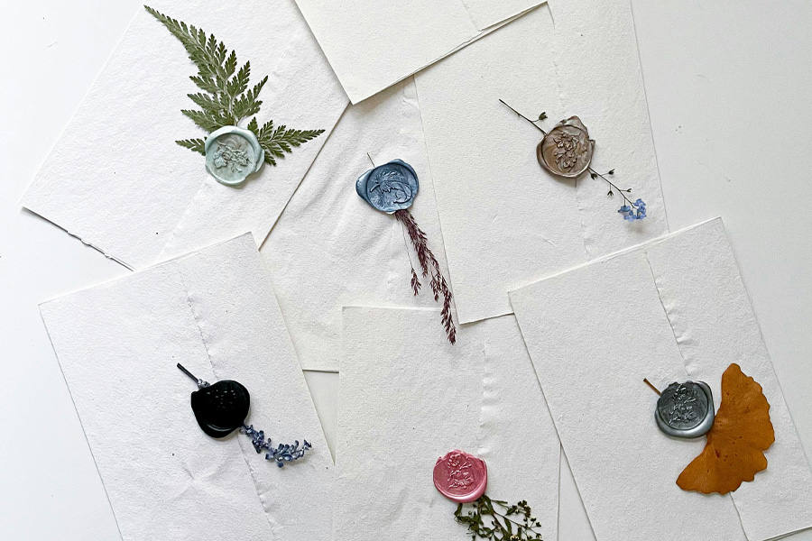 Dorset wedding stationery with wax seals and handmade paper invitation styling