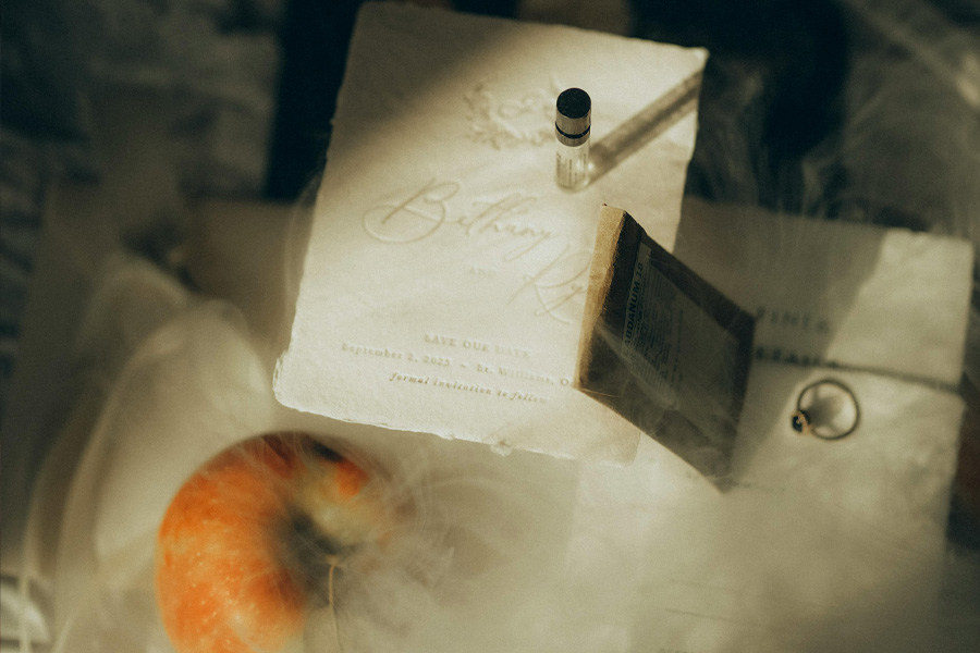 Luxury wedding invitation styled with perfume and bridal accessories for a Hampshire wedding