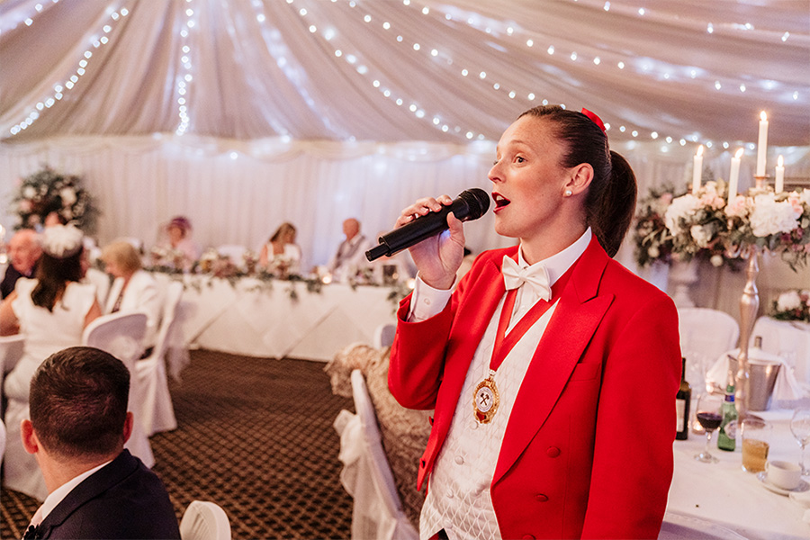 Mrs Toastmaster Dorset leading wedding party across country house wedding venue grounds<br />
