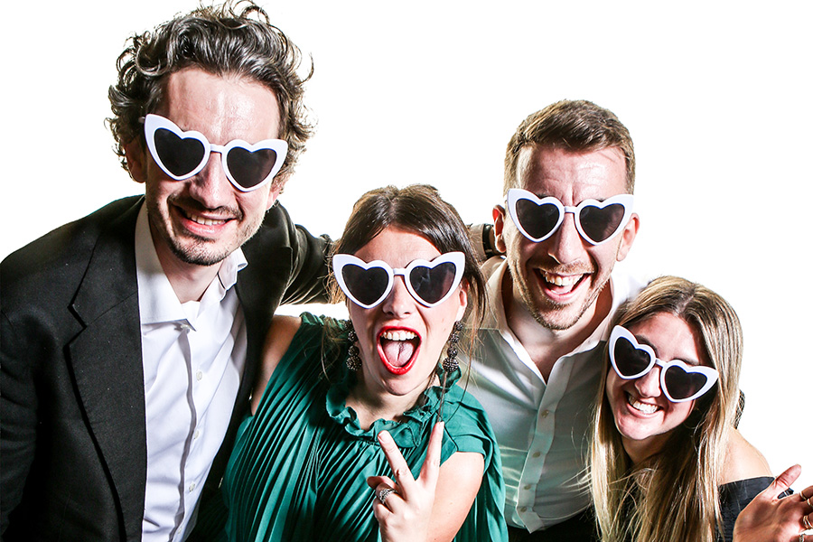 Two couples enjoying an open air wedding photo booth at a Dorset wedding reception