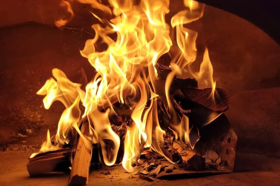 Wood fired pizza oven flames at Pizza With Love wedding catering service Hampshire