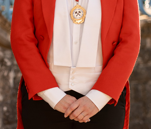 Wedding toastmaster striking ceremonial hammer to guide wedding day announcements