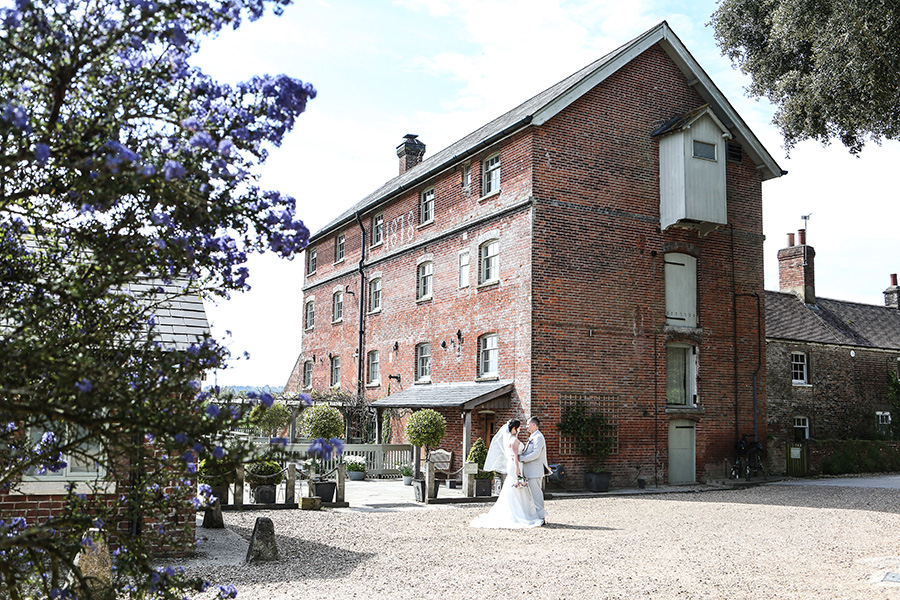Bride and groom outside Sopley Mill wedding venue in Dorset.