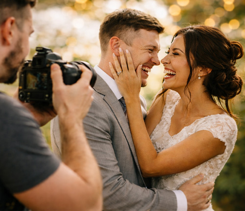 Bride and groom smiling during wedding photoshoot with photographer in Wiltshire
