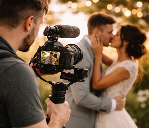 Dorset wedding videographer filming a bride and groom during golden hour