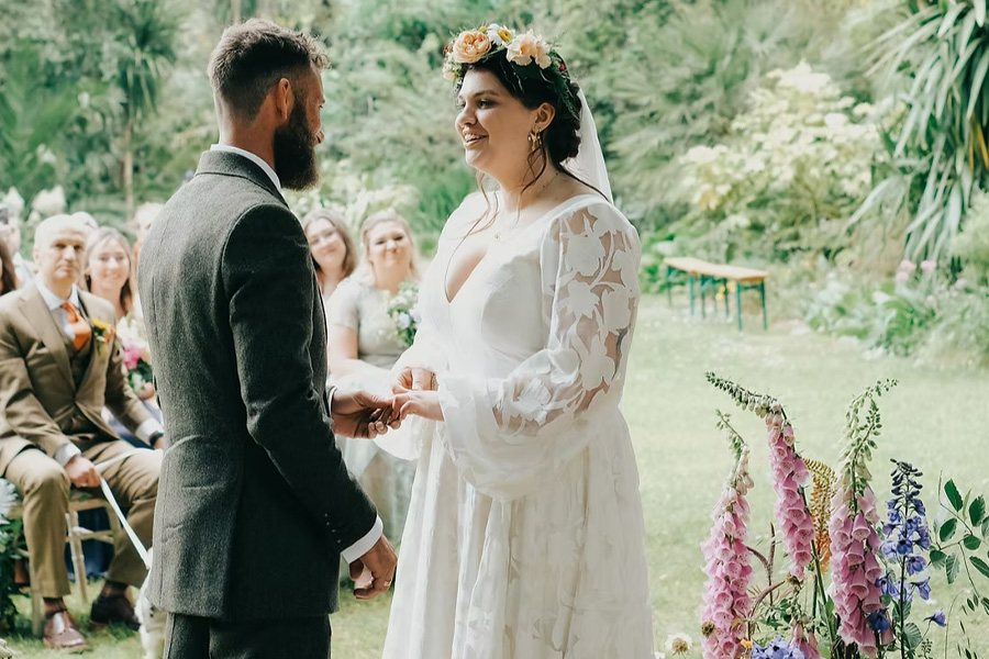 Outdoor wedding ceremony with floral arrangements by The English Garden Florist in Hampshire