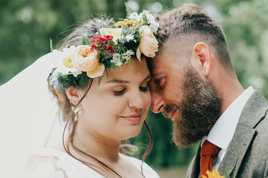 Bride wearing a natural seasonal flower crown by The English Garden Florist during outdoor wedding