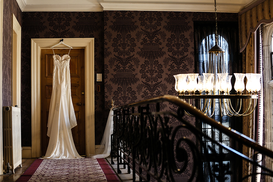 bridal dress hanging in a country house wedding venue in Hampshire with elegant manor interior