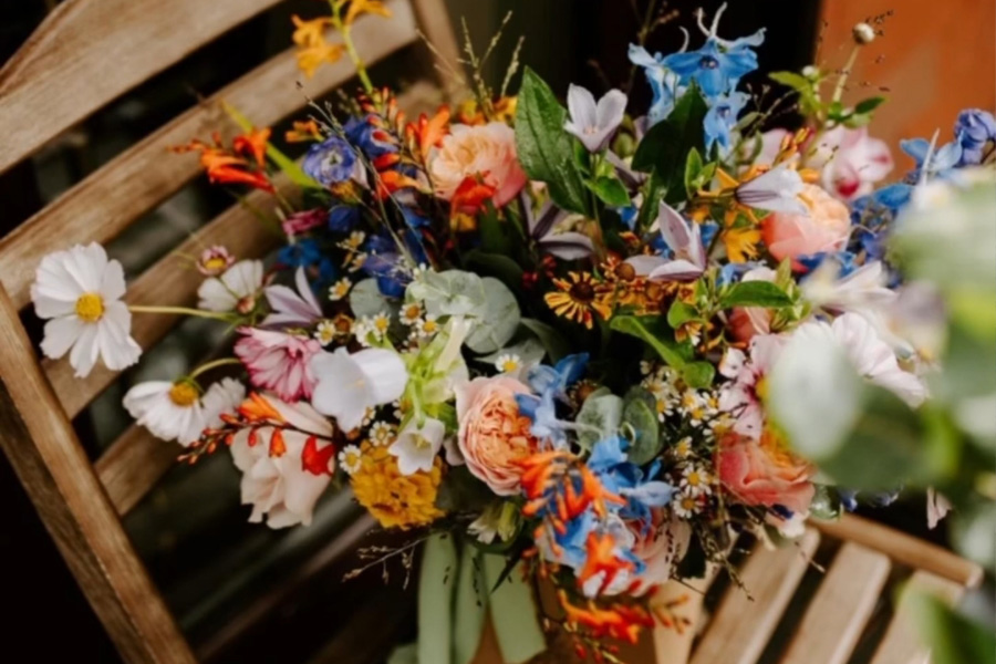 Colourful wedding bouquet by Ivy and Wild featuring seasonal flowers and natural styling, Wiltshire wedding florist