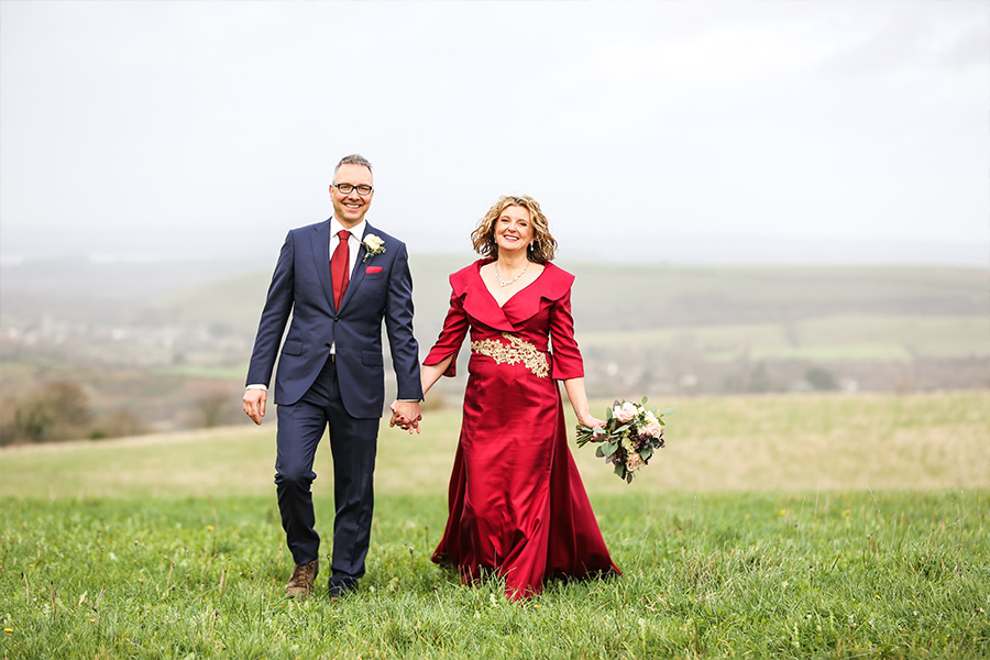 Bride and groom walking in countryside with views near Kingston Country Courtyard Dorset