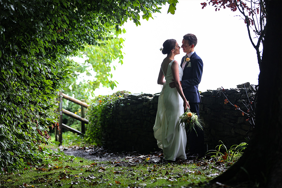 Bride and groom standing together on a garden path at Kingston Country Courtyard wedding venue in Dorset