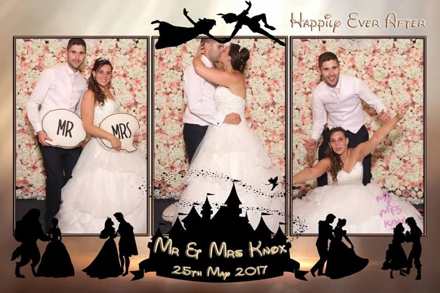 Wedding couple using a magic mirror photo booth with floral backdrop and personalised photo strip design