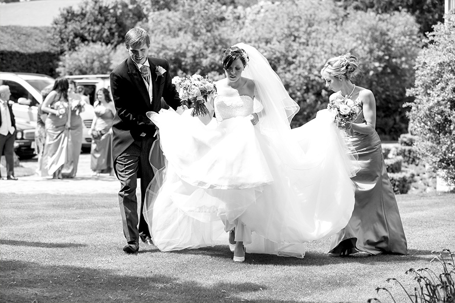 Bride walking with bridal party at outdoor Wiltshire wedding ceremony