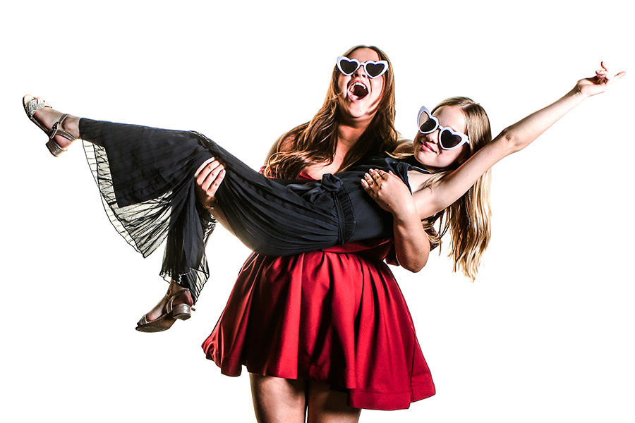 Wedding guests posing playfully in photo booth with heart glasses Wiltshire