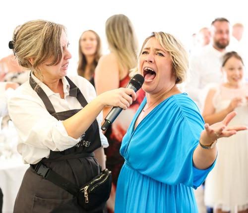 Wedding singer having fun during a the wedding breakfast