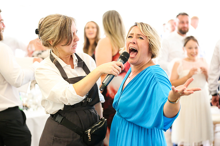 Guests enjoying interactive singing waiters entertainment at a Hampshire wedding reception