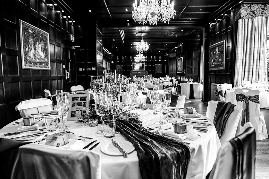 Wedding breakfast setup inside the Baronial Hall at Bartley Lodge, Hampshire.