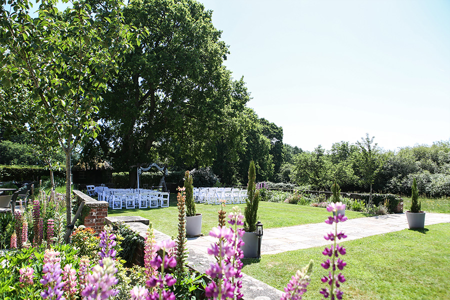 Outdoor wedding ceremony setup in the gardens of Bartley Lodge, New Forest, Hampshire.