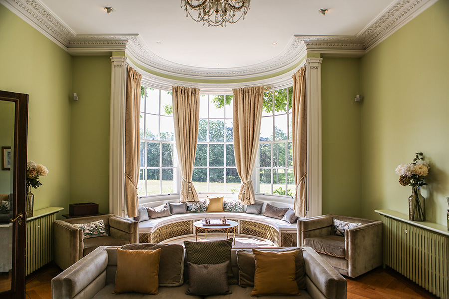 Elegant drawing room at Efford Park Manor, a luxury wedding venue in Hampshire featuring period architecture and panoramic countryside views.