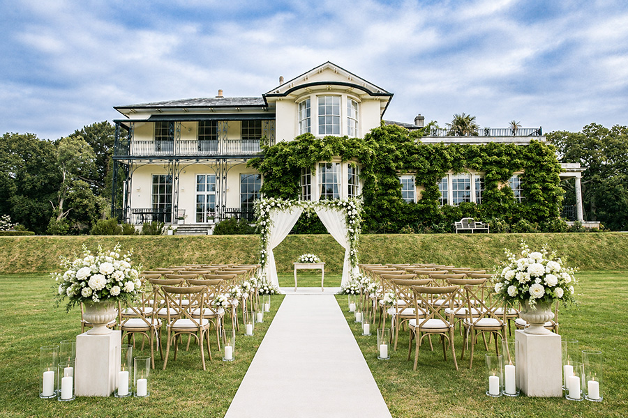 Outdoor wedding ceremony at Efford Park Manor, a luxury wedding venue in Hampshire surrounded by beautiful countryside and elegant gardens.