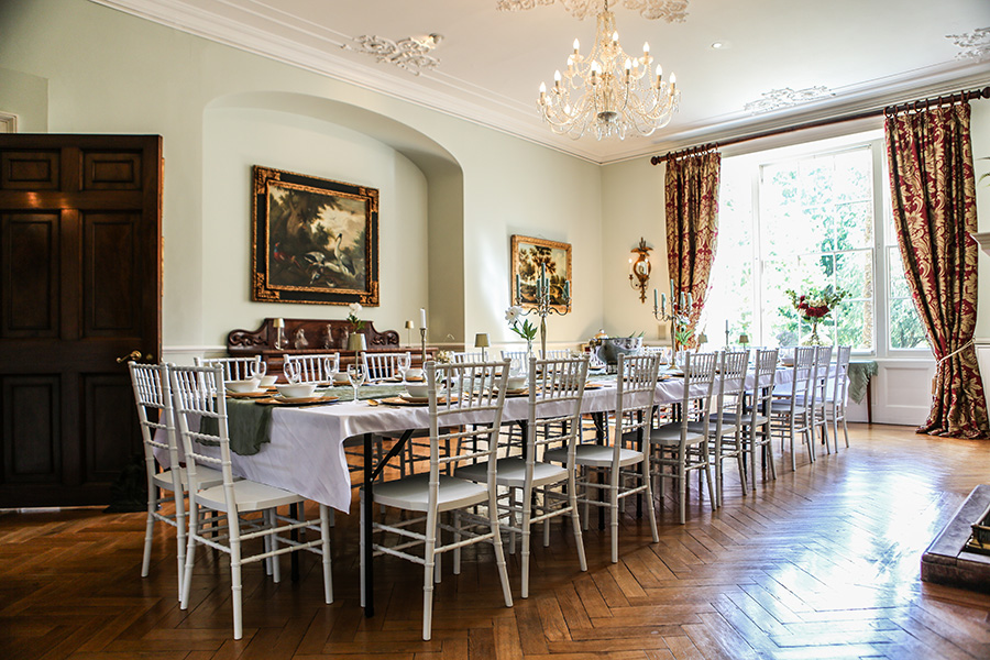Elegant private dining room at Efford Park Manor with long banquet table, chandeliers and period features for wedding celebrations.