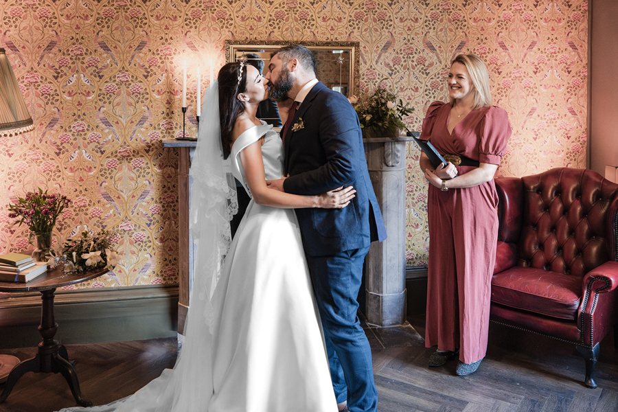 Couple sharing their first kiss during an intimate wedding ceremony at Fairlawn House A Little Place in Amesbury, Wiltshire