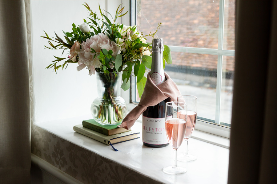 Champagne and fresh flowers displayed in a window at Fairlawn House A Little Place in Amesbury, Wiltshire