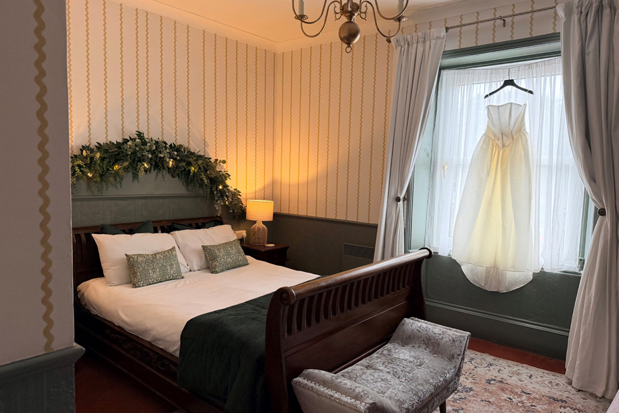 Wedding dress hanging in a boutique bridal suite at Fairlawn House A Little Place in Amesbury, Wiltshire