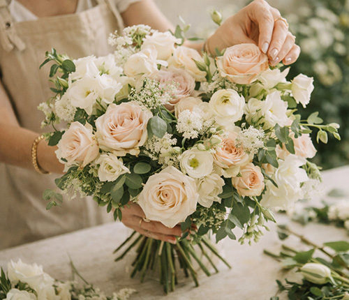 Luxury bridal bouquet featuring blush roses, white flowers and natural foliage created by a Wiltshire wedding florist.