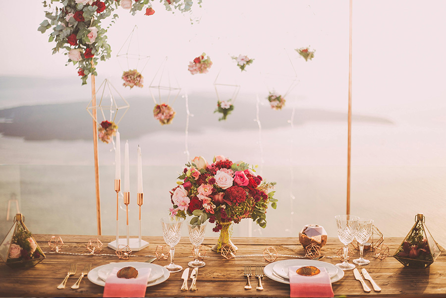 Elegant wedding table styling with floral centrepiece, candles and hanging flowers at a Wiltshire wedding reception.
